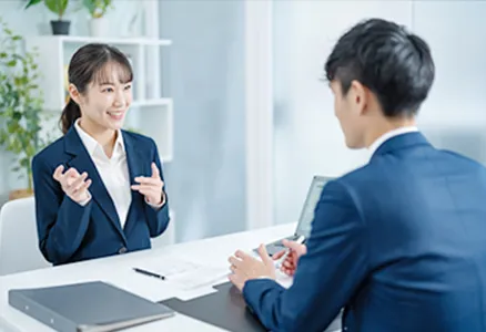 ふたりの社員が電卓を見ながら話している写真